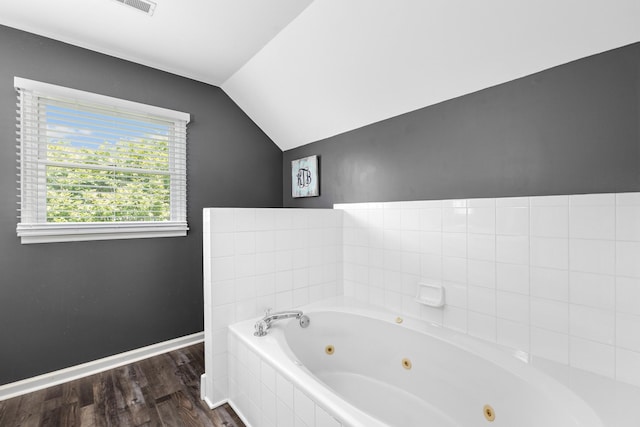 140 Keele Rd, Manchester, TN 37355 - bathroom featuring lofted ceiling, a whirlpool tub, wood finished floors, and baseboards