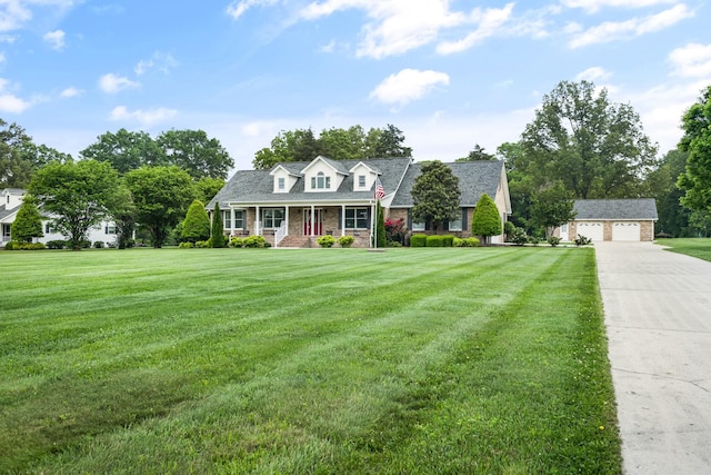 140 Keele Rd, Manchester, TN 37355 - cape cod house with an outbuilding, a porch, a detached garage, and a front yard
