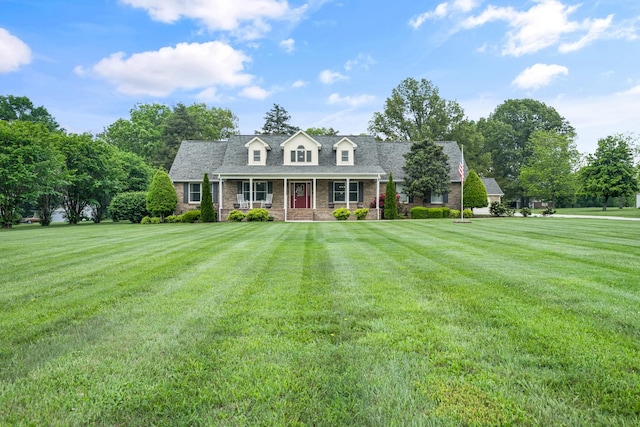 140 Keele Rd, Manchester, TN 37355 - cape cod house featuring covered porch, a front lawn, and brick siding