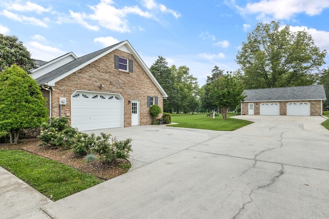 140 Keele Rd, Manchester, TN 37355 - view of property exterior featuring brick siding, a lawn, an outbuilding, and concrete driveway