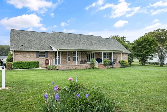 140 Keele Rd, Manchester, TN 37355 - view of front facade with a porch, a front lawn, brick siding, and a shingled roof