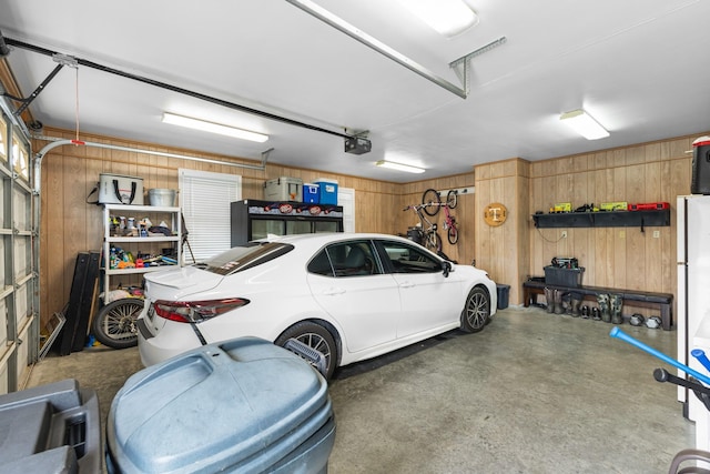 140 Keele Rd, Manchester, TN 37355 - garage with wood walls and a garage door opener