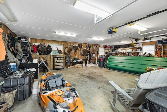 140 Keele Rd, Manchester, TN 37355 - garage featuring a workshop area, a garage door opener, and wooden walls