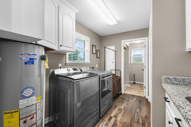 140 Keele Rd, Manchester, TN 37355 - washroom with gas water heater, independent washer and dryer, cabinet space, dark wood-style floors, and baseboards
