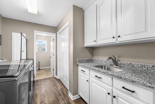 140 Keele Rd, Manchester, TN 37355 - laundry area featuring cabinet space, washer and clothes dryer, dark wood-style floors, and baseboards