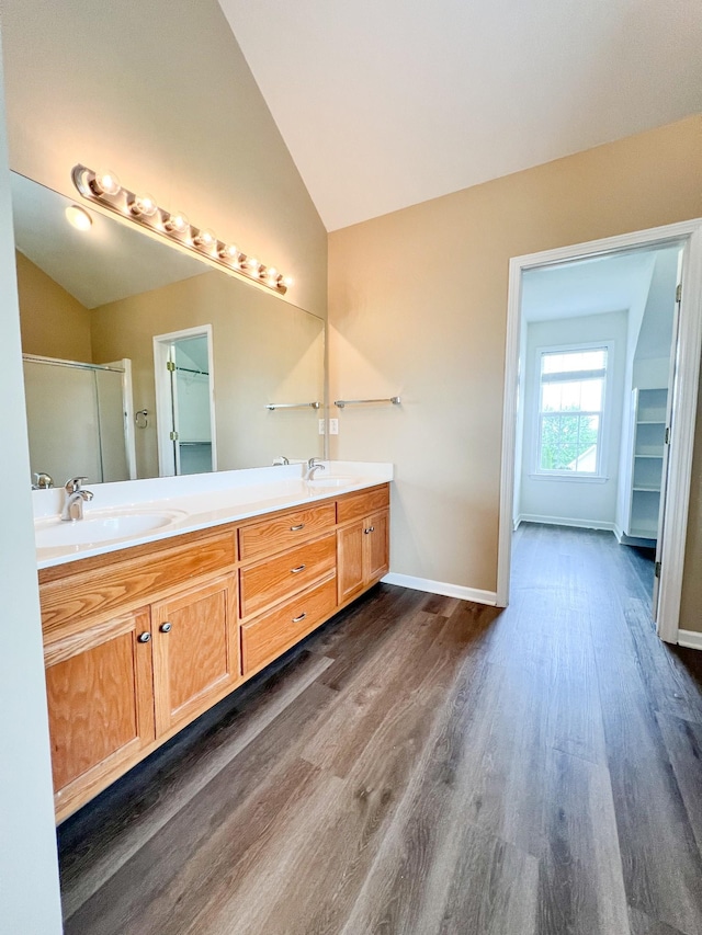 full bathroom with a sink, wood finished floors, and lofted ceiling