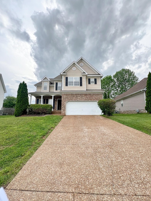 view of front facade featuring brick siding, a garage, a front lawn, and driveway