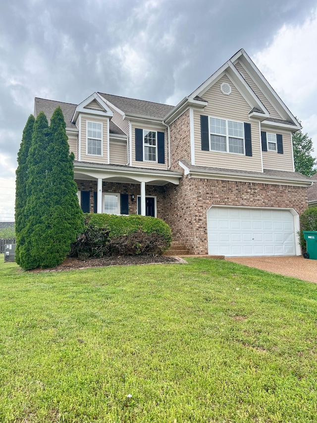 view of front facade with driveway, a front yard, and a garage