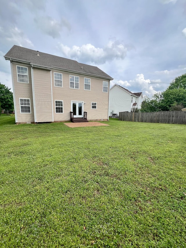 back of house featuring a patio area, fence, and a yard