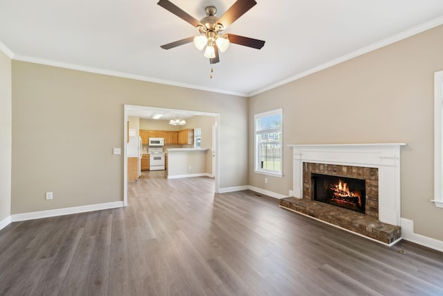 1030 Persimmon Dr, Spring Hill, TN 37174 - unfurnished living room with a brick fireplace, ornamental molding, wood finished floors, baseboards, and a ceiling fan