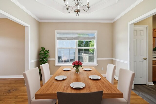 1030 Persimmon Dr, Spring Hill, TN 37174 - dining area with a chandelier, wood finished floors, crown molding, a tray ceiling, and baseboards