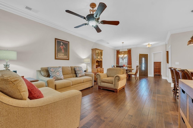 living room featuring crown molding, dark wood-style flooring, ceiling fan with notable chandelier, baseboards, and visible vents