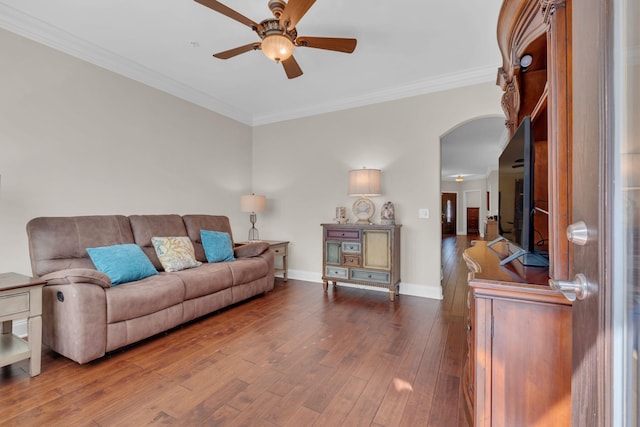 living room with crown molding, ceiling fan, arched walkways, baseboards, and wood finished floors