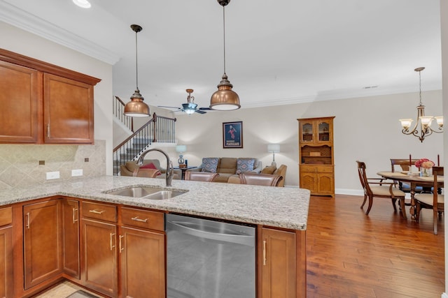 kitchen featuring stainless steel dishwasher, a sink, and brown cabinetry