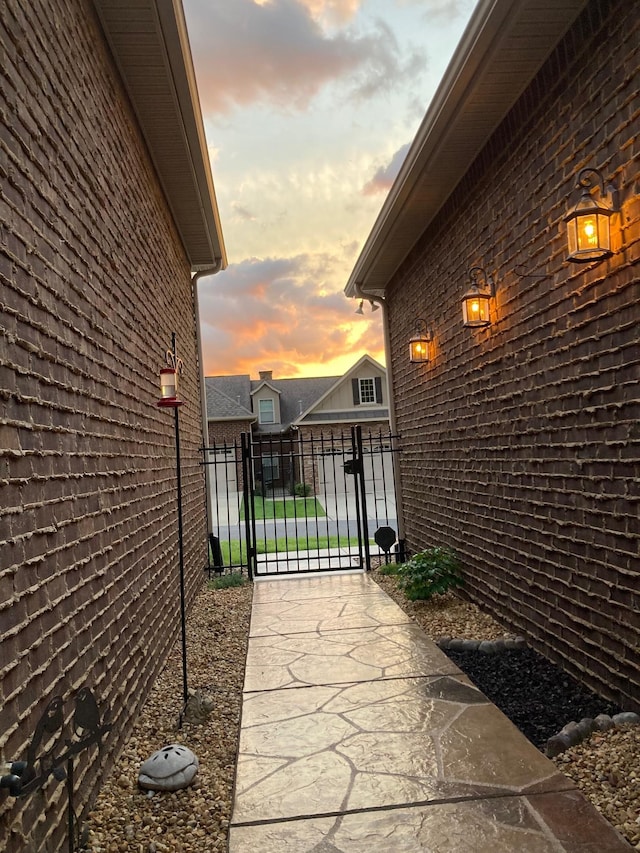 view of side of property with fence and a gate