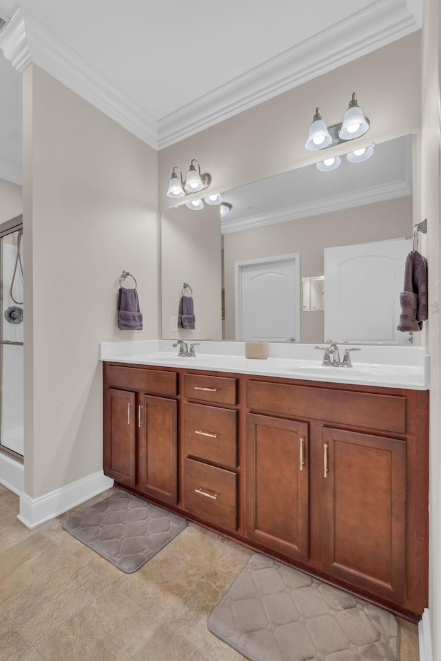 full bath featuring crown molding, double vanity, a shower stall, and a sink