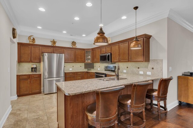 kitchen featuring a peninsula, glass insert cabinets, brown cabinets, a sink, and appliances with stainless steel finishes