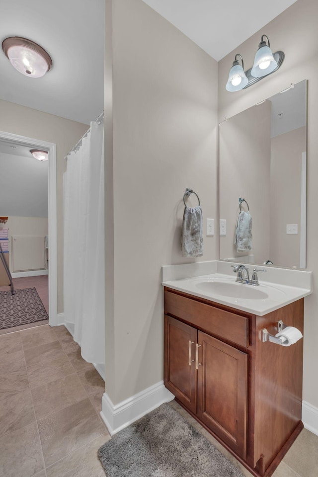 bathroom with baseboards, curtained shower, and vanity