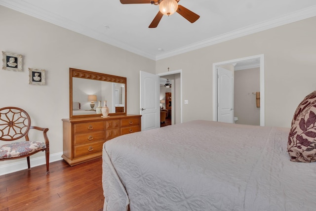 bedroom featuring crown molding, baseboards, ceiling fan, and wood finished floors