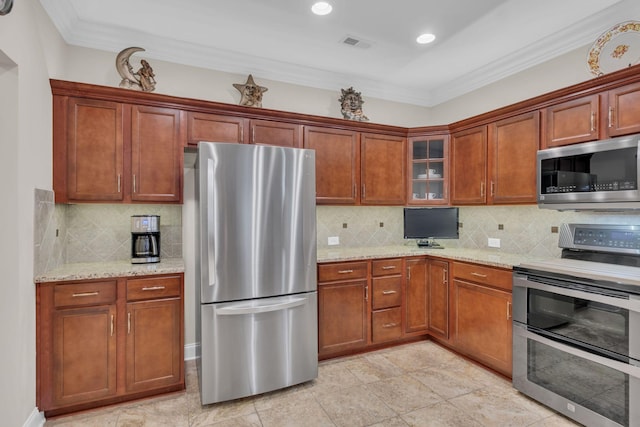 kitchen featuring visible vents, ornamental molding, light stone countertops, and stainless steel appliances