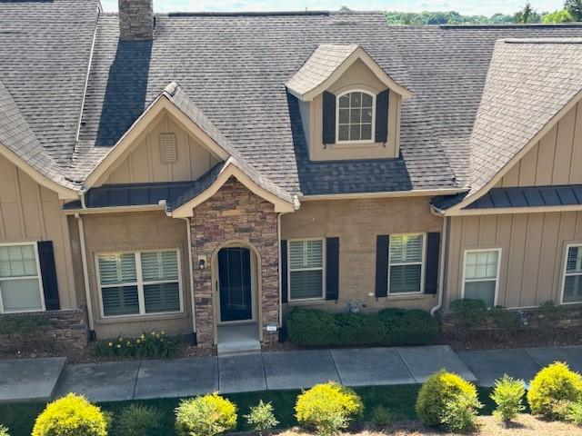 100 Placid Grove Ln Unit 2002, Goodlettsville, TN 37072 - view of front of property with board and batten siding, a chimney, roof with shingles, and stone siding