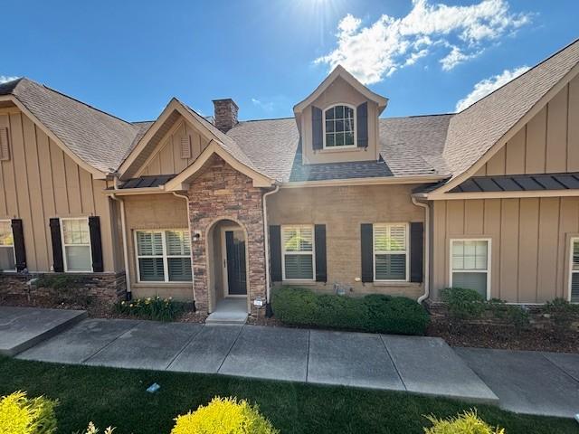 100 Placid Grove Ln Unit 2002, Goodlettsville, TN 37072 - view of front of property with a chimney, stone siding, roof with shingles, and board and batten siding