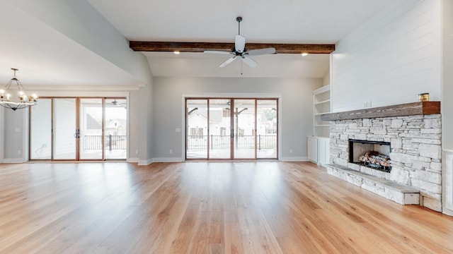 unfurnished living room featuring a stone fireplace, built in features, baseboards, ceiling fan with notable chandelier, and light wood finished floors
