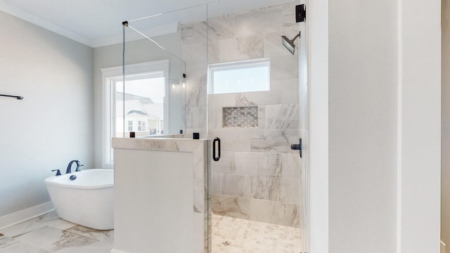 bathroom featuring a healthy amount of sunlight, a freestanding tub, a stall shower, and marble finish floor