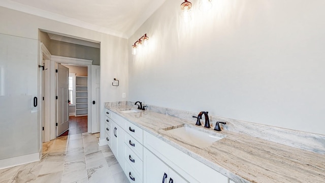 bathroom with double vanity, a spacious closet, a sink, and marble finish floor