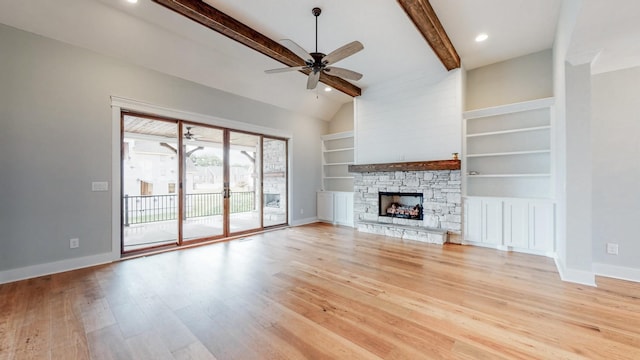 unfurnished living room featuring baseboards, lofted ceiling with beams, built in shelves, a ceiling fan, and light wood-style flooring