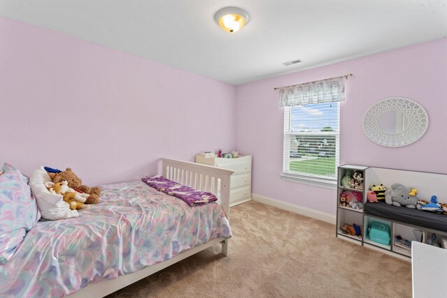 carpeted bedroom featuring baseboards and visible vents