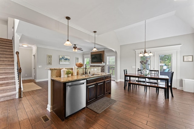 kitchen featuring a sink, arched walkways, dark wood finished floors, ceiling fan with notable chandelier, and dishwasher
