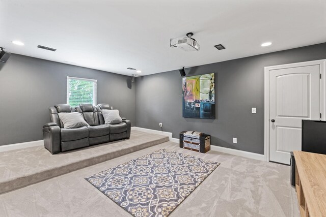 cinema room with light colored carpet, recessed lighting, baseboards, and visible vents