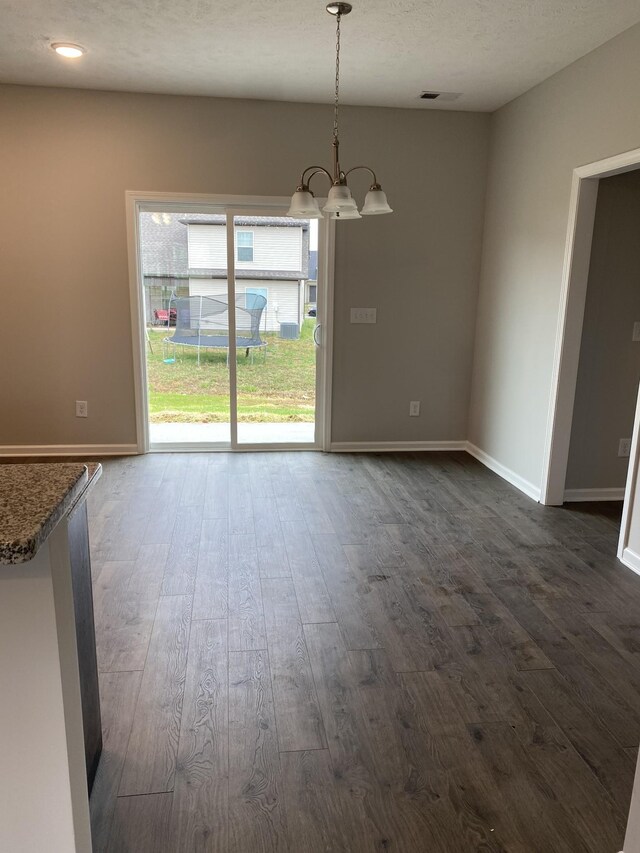 103 Glentree Cv, Smyrna, TN 37167 - unfurnished dining area featuring a chandelier, dark wood-type flooring, and baseboards