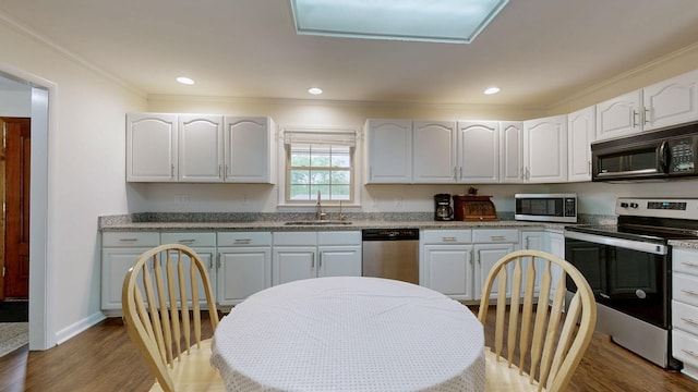 1213 Shackelford Dr, Mount Pleasant, TN 38474 - kitchen with crown molding, dark wood-style floors, white cabinets, a sink, and appliances with stainless steel finishes
