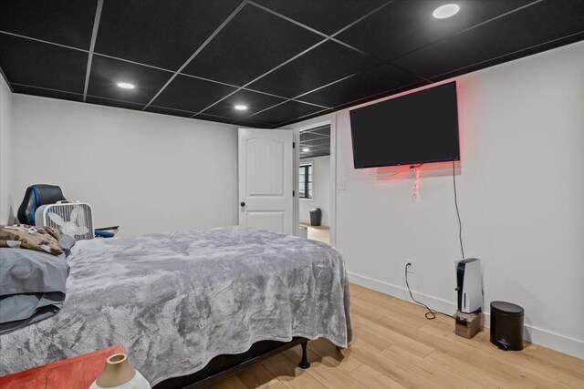 bedroom with baseboards, recessed lighting, and wood finished floors