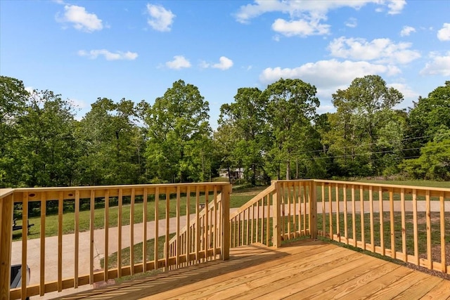 wooden deck featuring a yard