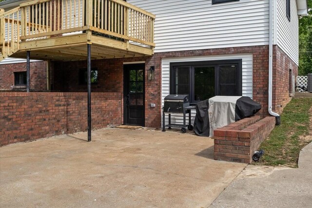 view of patio / terrace featuring a deck and a grill