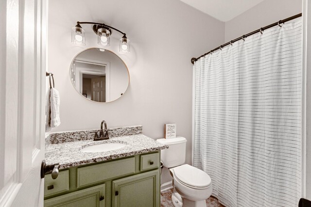 bathroom featuring vanity, toilet, and a shower with shower curtain