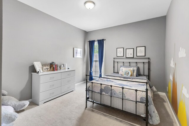 bedroom with carpet flooring and baseboards