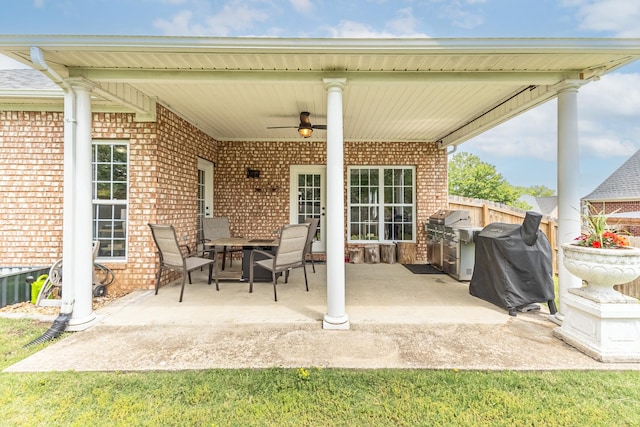 view of patio / terrace with a ceiling fan, outdoor dining space, fence, and a grill