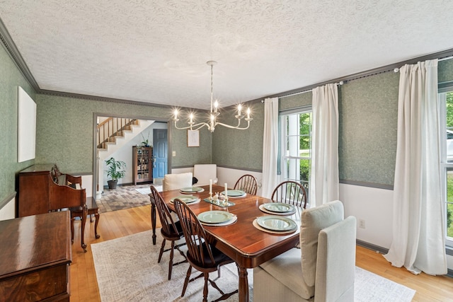 319 Powder Mill Dr, Ashland City, TN 37015 - dining area with a textured ceiling, wallpapered walls, and wood finished floors