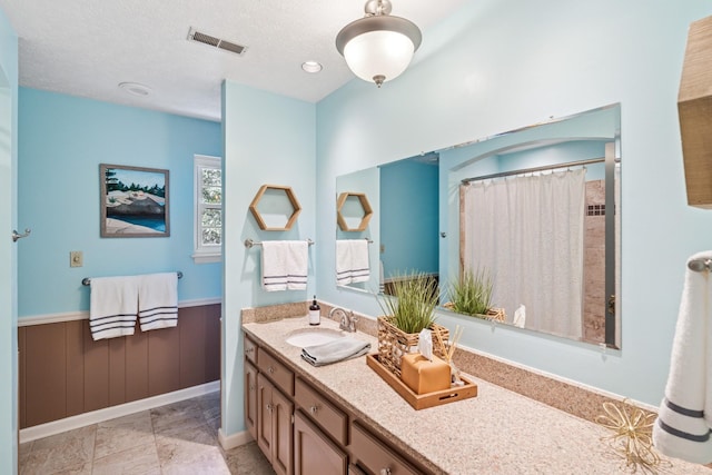 319 Powder Mill Dr, Ashland City, TN 37015 - bathroom with visible vents, a wainscoted wall, a shower with curtain, and vanity