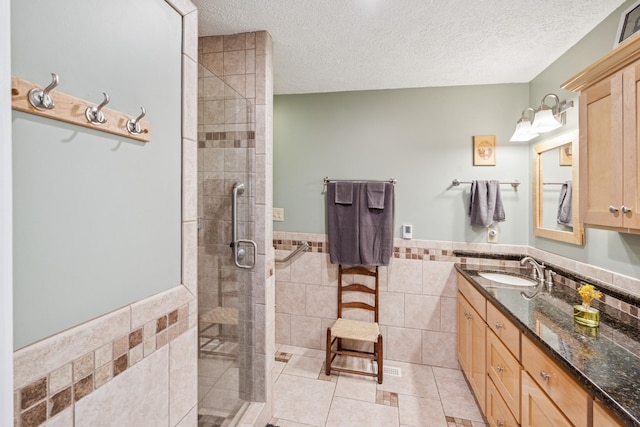 319 Powder Mill Dr, Ashland City, TN 37015 - full bathroom featuring tile walls, tile patterned flooring, a tile shower, vanity, and a wainscoted wall