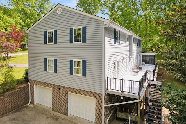 319 Powder Mill Dr, Ashland City, TN 37015 - back of property featuring a wooden deck, brick siding, an attached garage, driveway, and stairway