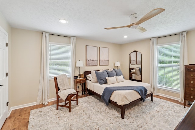 319 Powder Mill Dr, Ashland City, TN 37015 - bedroom with a textured ceiling, baseboards, a ceiling fan, and light wood-style flooring