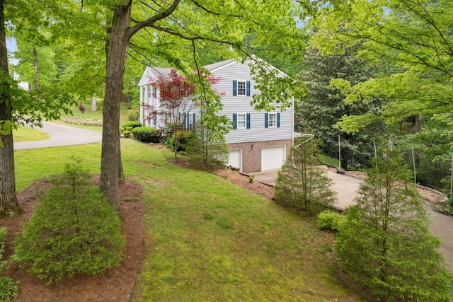 319 Powder Mill Dr, Ashland City, TN 37015 - view of property exterior featuring a yard, an attached garage, concrete driveway, and brick siding