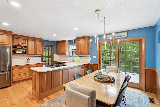 319 Powder Mill Dr, Ashland City, TN 37015 - kitchen featuring freestanding refrigerator, wainscoting, a wealth of natural light, and light countertops