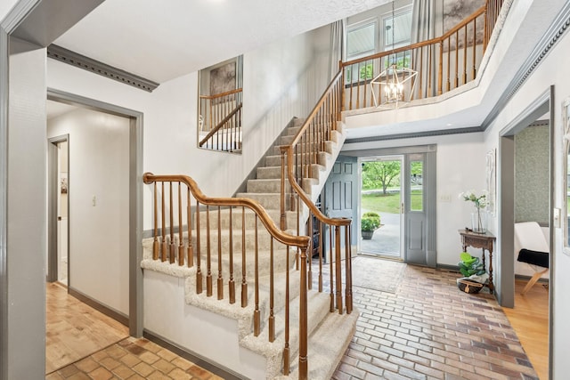 319 Powder Mill Dr, Ashland City, TN 37015 - staircase featuring an inviting chandelier, baseboards, and brick floor