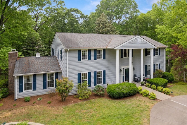 319 Powder Mill Dr, Ashland City, TN 37015 - neoclassical / greek revival house with a chimney, a shingled roof, and a front lawn